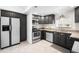 Updated kitchen featuring dark cabinets, stainless steel appliances, and unique hexagon-tiled flooring at 404 S Jasmine St, Denver, CO 80224