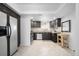 Modern kitchen featuring dark cabinets, stainless steel appliances, and unique hexagon-tiled flooring at 404 S Jasmine St, Denver, CO 80224