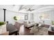 Cozy living room with wood floors, white sofa and chairs, ceiling fan, and dining table at 404 S Jasmine St, Denver, CO 80224