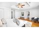 This spacious main bedroom has hardwood floors, white walls, ceiling fan and a sitting area at 404 S Jasmine St, Denver, CO 80224