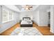 Inviting main bedroom with natural light, hardwood floors, and ensuite bathroom at 404 S Jasmine St, Denver, CO 80224