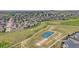 Aerial view of a neighborhood featuring a golf course, tennis court, and bocce ball court at 5280 Genoa St, Denver, CO 80249