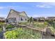 Well-maintained backyard featuring raised garden beds and a stylish pergola for outdoor enjoyment and relaxation at 5280 Genoa St, Denver, CO 80249