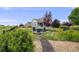 Relax in this backyard with a fire pit, wildflowers, and a walking path to enjoy the outdoors at 5280 Genoa St, Denver, CO 80249