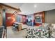 This finished basement has a bar with seating, a TV area, and eclectic decor for entertaining and relaxation at 5280 Genoa St, Denver, CO 80249