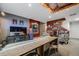 This finished basement is perfect for entertainment with a TV area, bar, and fireplace for cozy relaxation at 5280 Genoa St, Denver, CO 80249
