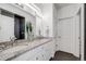 Modern bathroom with double sinks, granite countertop, and sleek fixtures at 5280 Genoa St, Denver, CO 80249