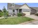 Inviting home featuring stone accents and lush green lawn at 5280 Genoa St, Denver, CO 80249