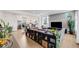 Open-concept living room with a kitchen in the background and modern decor at 5280 Genoa St, Denver, CO 80249