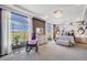 Bright bedroom features abundant natural light, stylish decor, and serene outdoor views at 5280 Genoa St, Denver, CO 80249