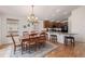 Bright dining area with a wooden table, chairs, and an adjacent kitchen with barstool seating at 23941 E Whitaker Dr, Aurora, CO 80016