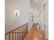 Hallway featuring hardwood floors, white walls and columns, and a wooden handrail at 23941 E Whitaker Dr, Aurora, CO 80016