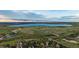 Scenic aerial view of a neighborhood surrounded by lush greenery and tranquil lake, perfect for outdoor activities at 5227 S Geneva St, Englewood, CO 80111