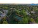 Beautiful aerial view of a lush residential area with mature trees and a well-maintained tennis court at 5227 S Geneva St, Englewood, CO 80111
