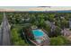 Aerial view of a community pool and playground surrounded by lush greenery and single Gathering homes at 5227 S Geneva St, Englewood, CO 80111