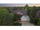 An aerial view of a large home with a three car garage surrounded by mature trees and landscaping at 5227 S Geneva St, Englewood, CO 80111