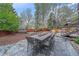 Inviting backyard with stone patio, outdoor dining area, hot tub, and outdoor kitchen at 5227 S Geneva St, Englewood, CO 80111