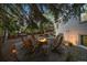 Outdoor living space around a fire pit with a brick home in the background at 5227 S Geneva St, Englewood, CO 80111