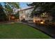 An expansive lawn with dining area and a sunken fire pit seating area grace this spacious backyard at 5227 S Geneva St, Englewood, CO 80111