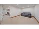 Unfinished basement area with a couch and an additional room great for storage or to convert to another bedroom at 5227 S Geneva St, Englewood, CO 80111