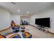 Finished basement with gaming chairs and large flat screen, perfect for a relaxing recreation area at 5227 S Geneva St, Englewood, CO 80111
