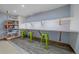 Finished basement space with custom shelving, a long table, and lime green stools at 5227 S Geneva St, Englewood, CO 80111