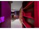 Basement hallway with built in shelves leading to a game area at 5227 S Geneva St, Englewood, CO 80111