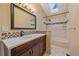 Bathroom featuring marble countertops, modern fixtures, and a shower/tub combination at 5227 S Geneva St, Englewood, CO 80111