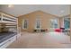 Bedroom featuring a bunk bed set, multiple windows providing natural light, and a spacious area for activities at 5227 S Geneva St, Englewood, CO 80111