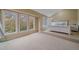A bedroom with a white bed frame, large windows with views, and neutral decor creates a serene retreat at 5227 S Geneva St, Englewood, CO 80111