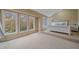 Bright bedroom with large windows, a raised area for the bed, and a calm, inviting atmosphere at 5227 S Geneva St, Englewood, CO 80111