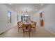 Spacious dining room with large windows and a long wooden table at 5227 S Geneva St, Englewood, CO 80111