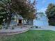 Charming home with a well-manicured lawn, brick accents, mature trees, and a three car garage at 5227 S Geneva St, Englewood, CO 80111