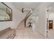 Bright foyer with grand staircase, tiled floors, and elegant decorative touches at 5227 S Geneva St, Englewood, CO 80111