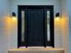 The front door features decorative glass sidelights and modern sconces creating a welcoming entrance at 5227 S Geneva St, Englewood, CO 80111