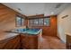 Indoor hot tub room with wood paneling and natural light from windows at 5227 S Geneva St, Englewood, CO 80111