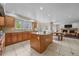 Open kitchen with island, granite countertops, stainless appliances, and view into the living room and fireplace at 5227 S Geneva St, Englewood, CO 80111