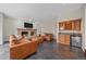 Cozy living room featuring a stone fireplace, wet bar, wine rack, comfortable seating and a flat screen television at 5227 S Geneva St, Englewood, CO 80111