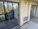 Exterior view of a condo balcony with sliding glass doors, brick detail, and tree views at 13601 E Marina Dr # 510, Aurora, CO 80014