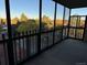 Enclosed balcony with glass and metal railings, offering views of the surrounding trees at 13601 E Marina Dr # 510, Aurora, CO 80014