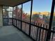 Enclosed balcony with city views through large glass windows, and black iron railings at 13601 E Marina Dr # 510, Aurora, CO 80014