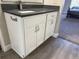 Bathroom vanity featuring white cabinets, modern hardware, and a gray countertop at 13601 E Marina Dr # 510, Aurora, CO 80014