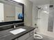 Bathroom featuring a vanity, framed mirror, and shower over the tub at 13601 E Marina Dr # 510, Aurora, CO 80014