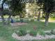 A landscaped exterior view shows trees, shrubs and a patio at 13601 E Marina Dr # 510, Aurora, CO 80014