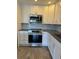 Updated kitchen with white cabinets, granite countertops, and stainless steel appliances at 13601 E Marina Dr # 510, Aurora, CO 80014