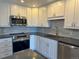Close-up of a modern kitchen featuring stainless appliances and granite countertops at 13601 E Marina Dr # 510, Aurora, CO 80014