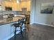 Kitchen with gray countertops, modern appliances, an island with chairs, and hardwood flooring at 13601 E Marina Dr # 510, Aurora, CO 80014
