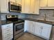 Updated kitchen featuring stainless steel appliances and white cabinets at 13601 E Marina Dr # 510, Aurora, CO 80014