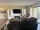 Open-concept living room featuring modern entertainment center and balcony access at 13601 E Marina Dr # 510, Aurora, CO 80014