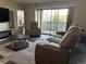 Cozy living room featuring modern furnishings, a coffee table, and balcony access at 13601 E Marina Dr # 510, Aurora, CO 80014
